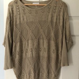 Neutral beige light loose knit sweater. Sleeves fall at elbows.